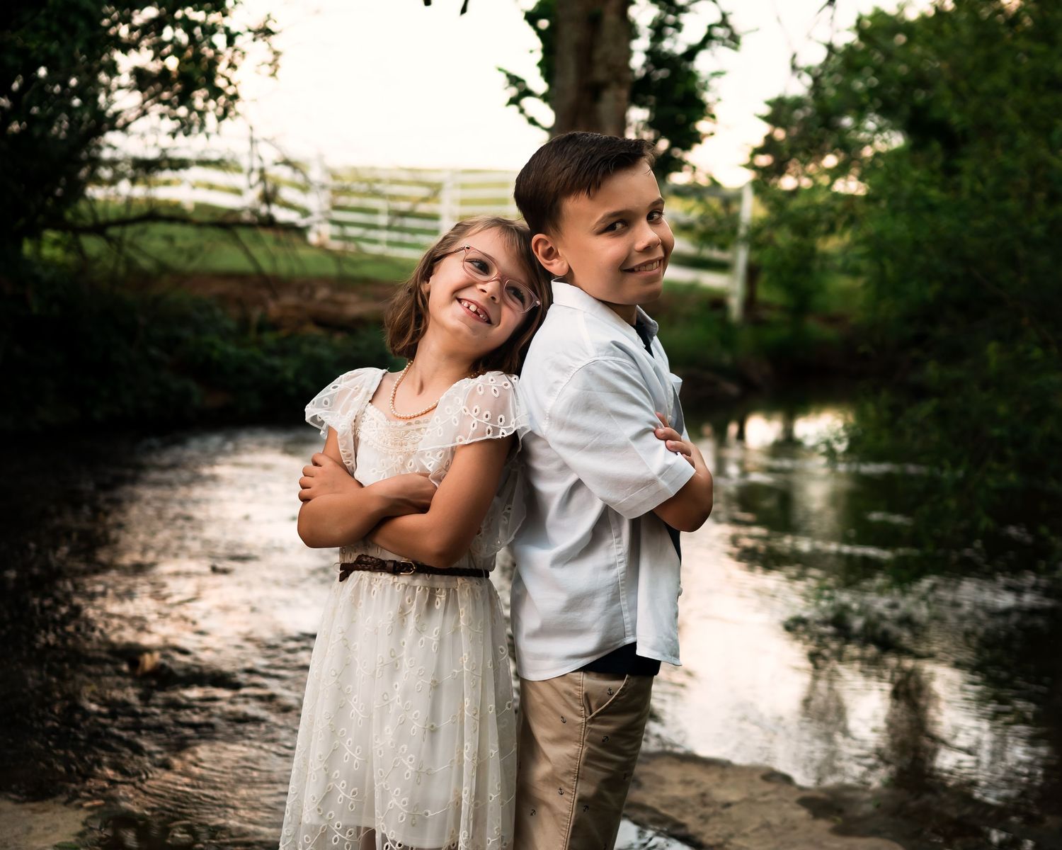 Children playing near water's edge at dusk.