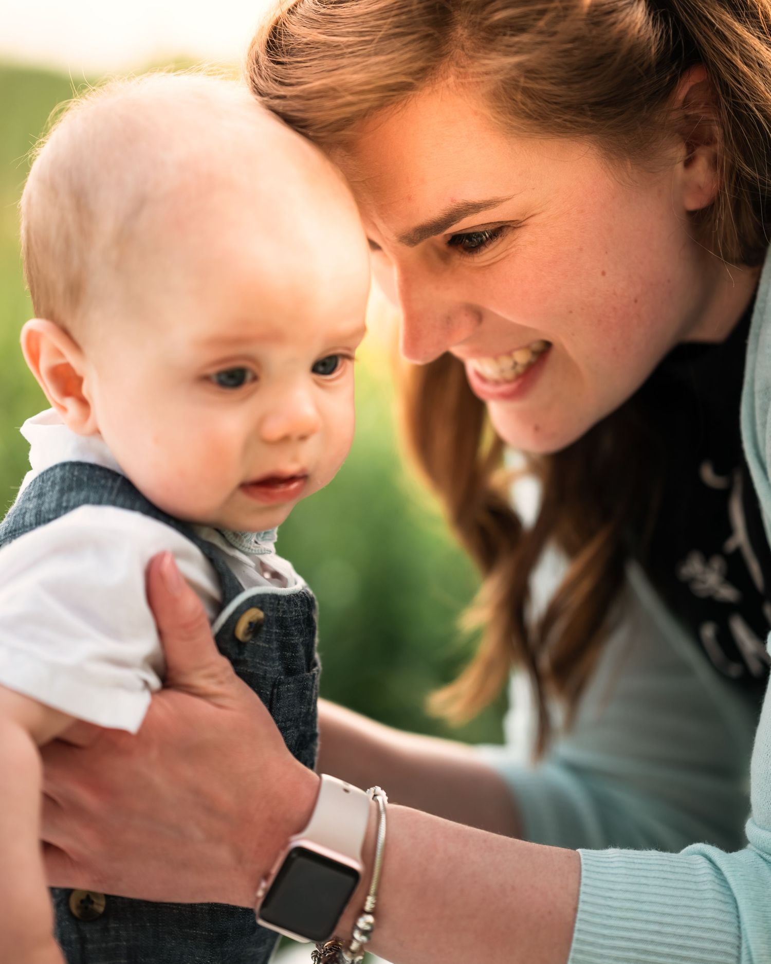 Tender moment captured in soft natural lighting outdoors.