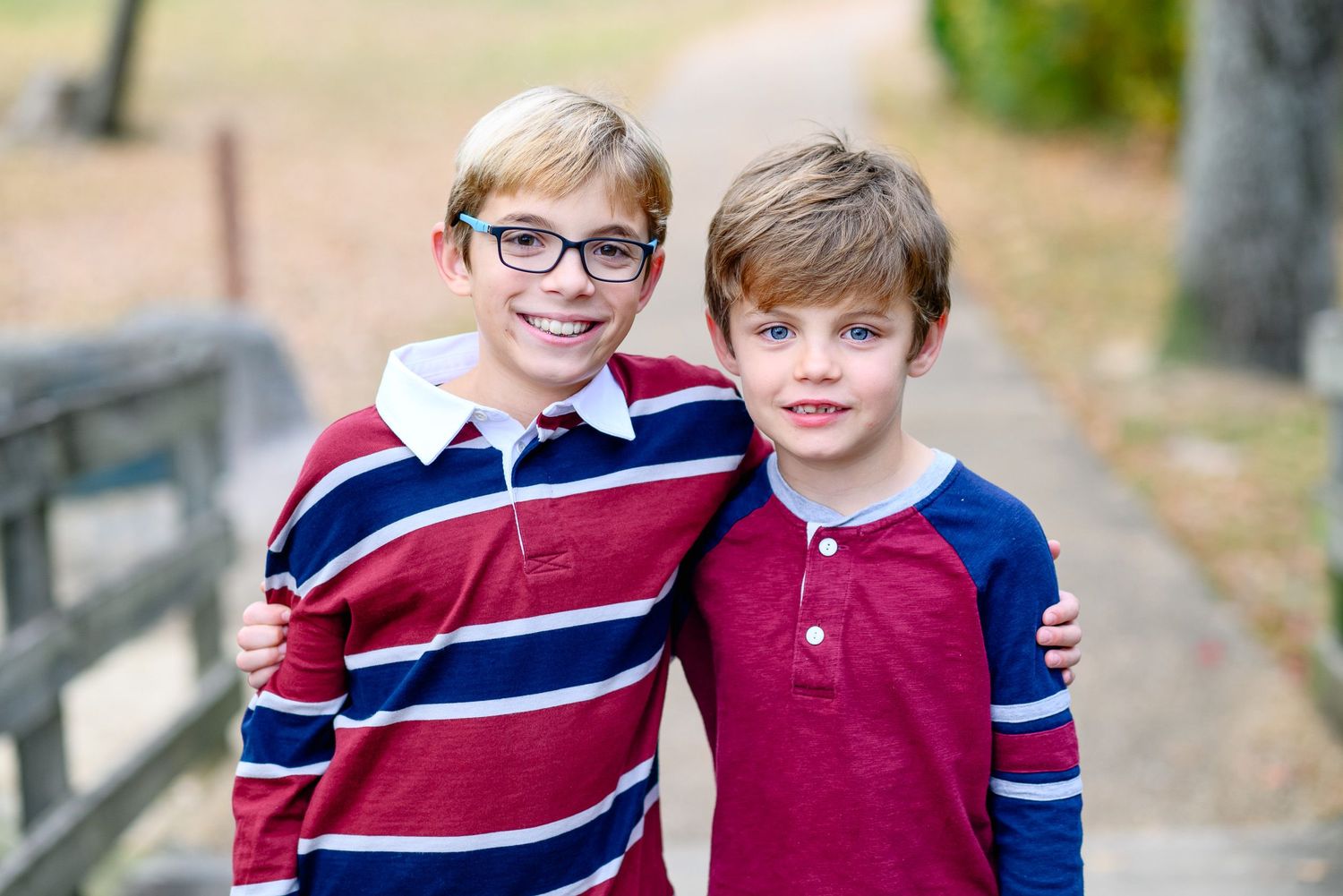 brothers hugging in park golden hour