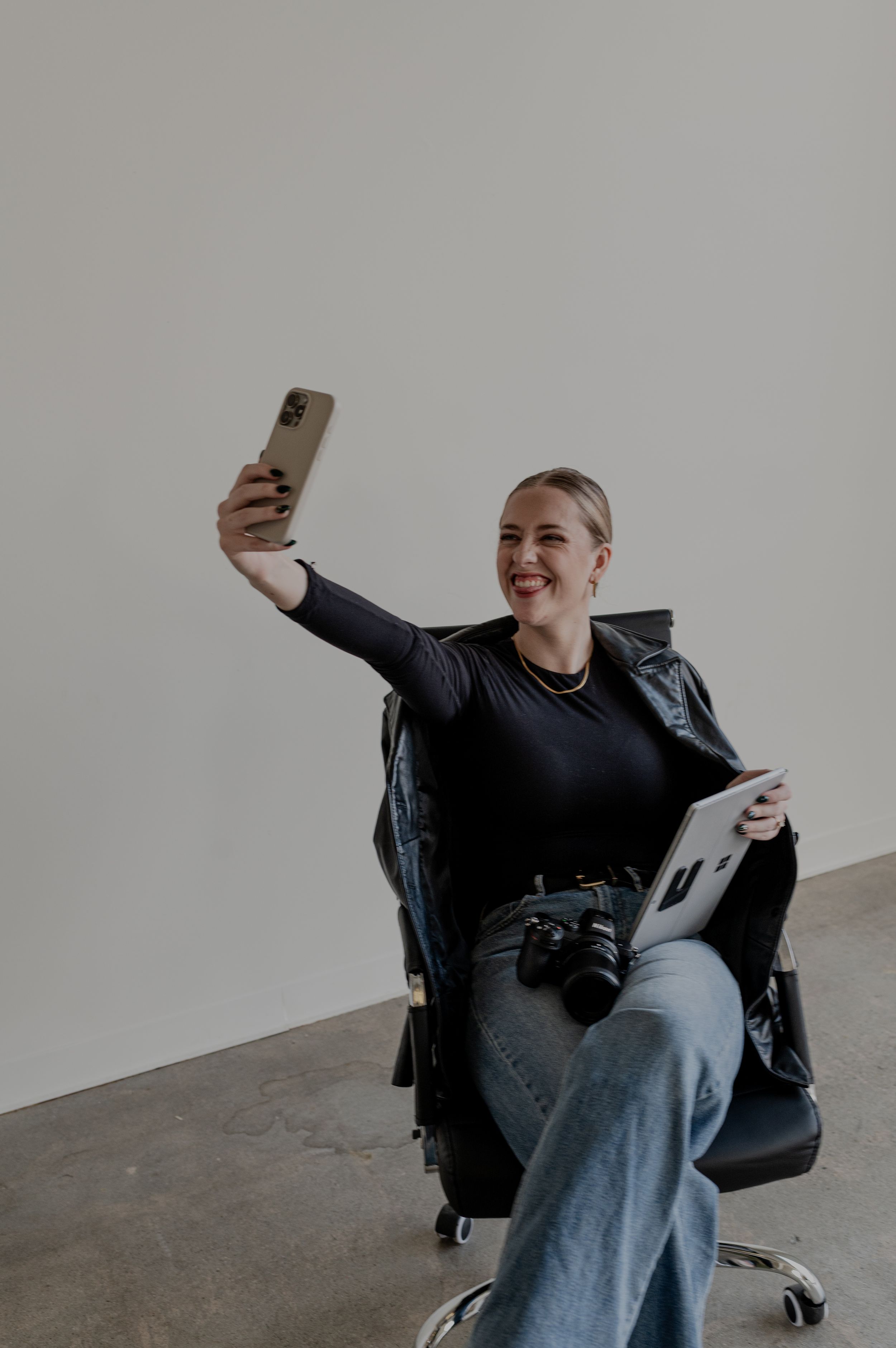 Creative self-portrait scene with photographer in office chair.