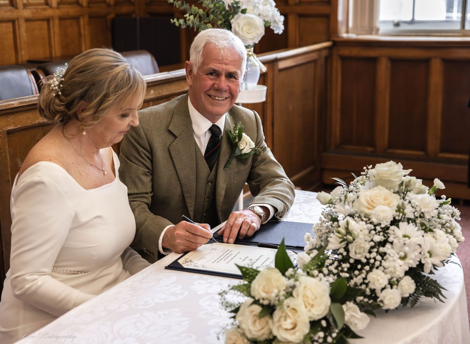 Couple signing at wedding ceremony