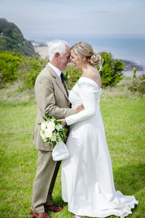 Bride and groom heads together on the cliffs