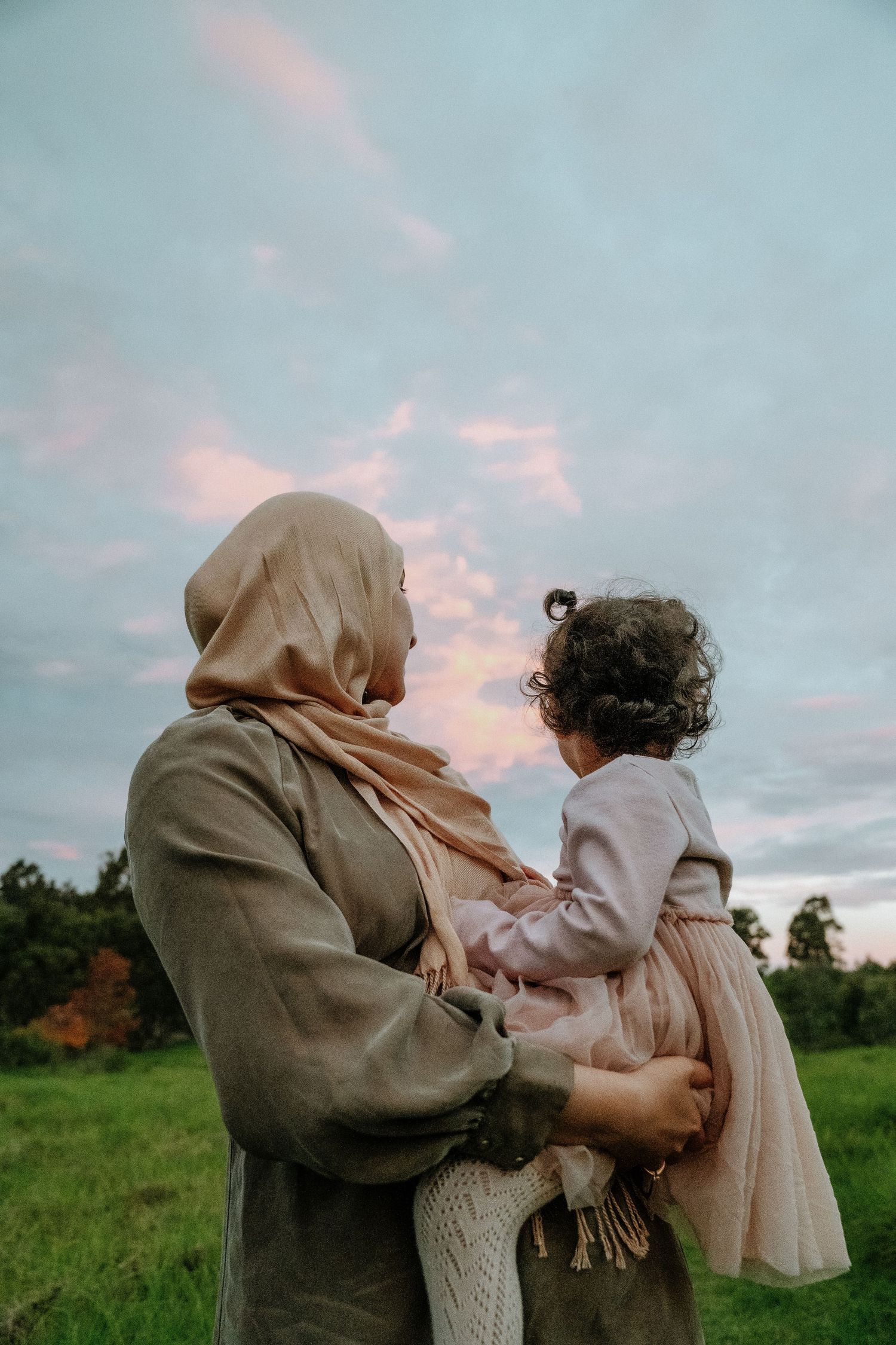 Mother and daughter hugging during a blue hour photo shoot and sky gazing at The Dairy, Western Sydney Parklands.
