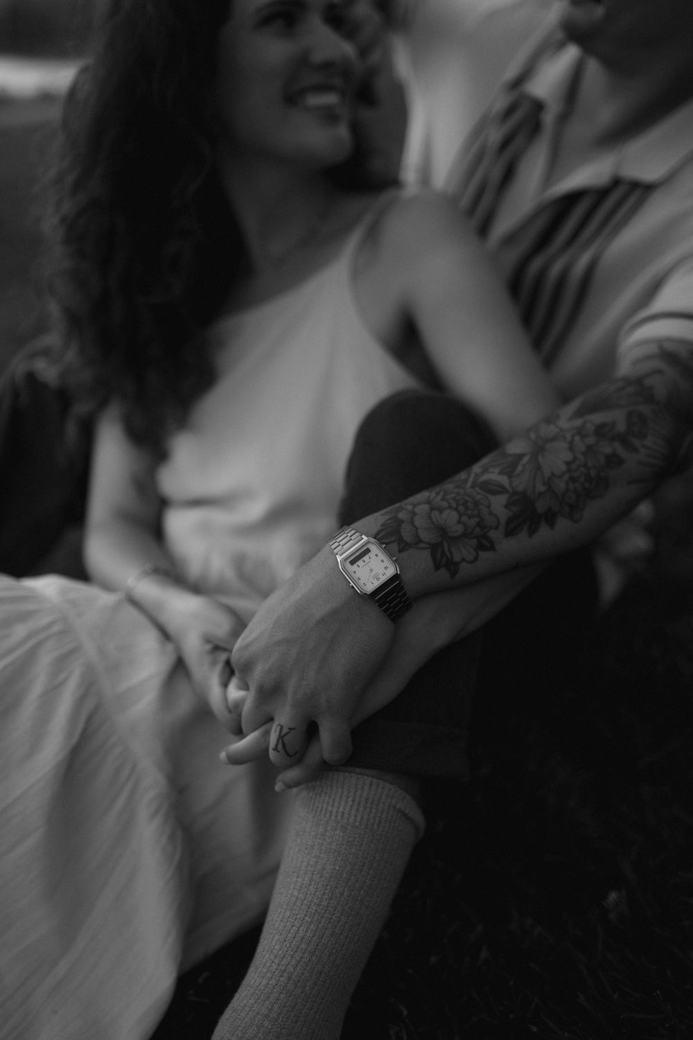 Close-up shot of a ring exchange during a loving engagement moment.