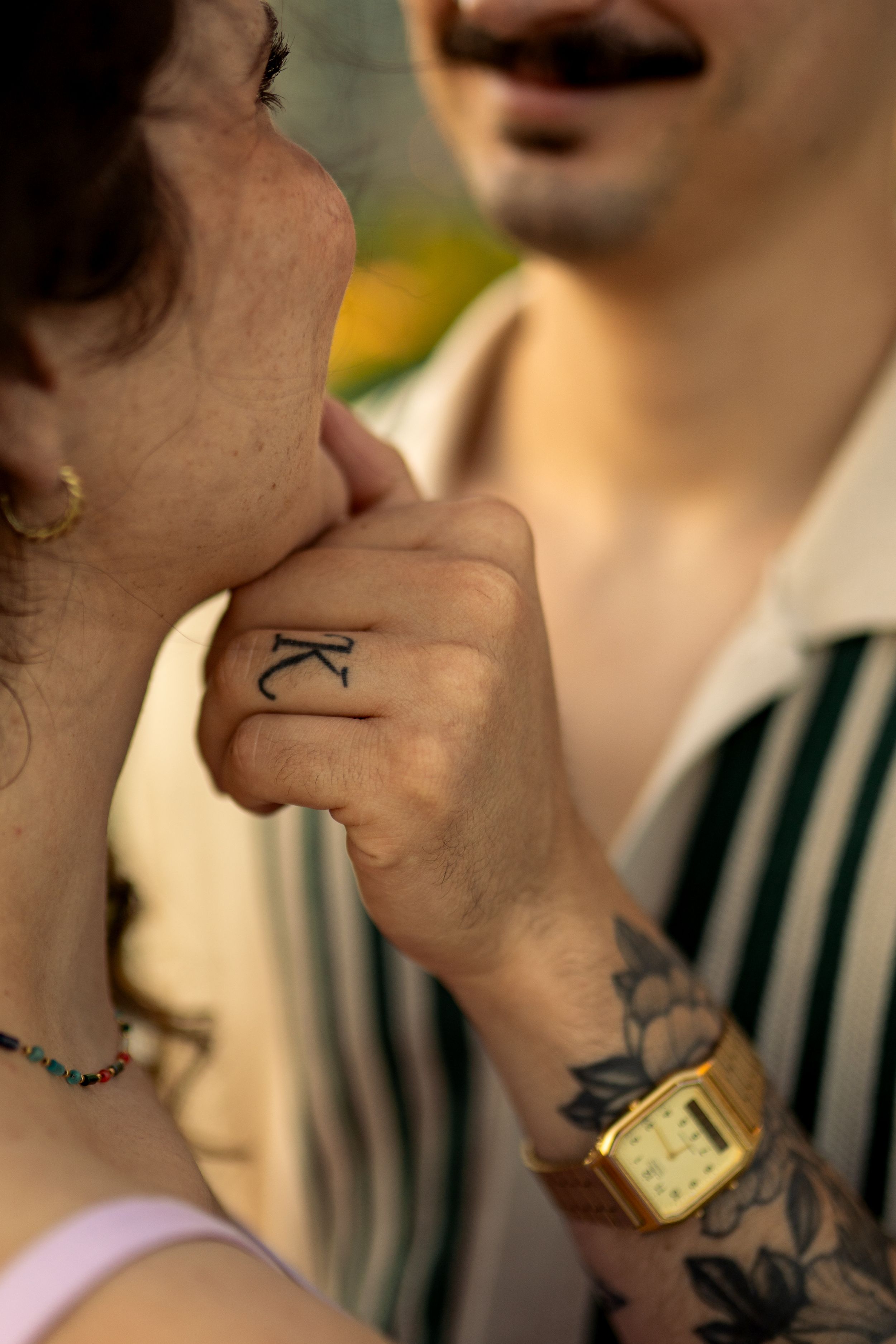 Artistic detail shots of hands and jewelry in warm natural lighting.