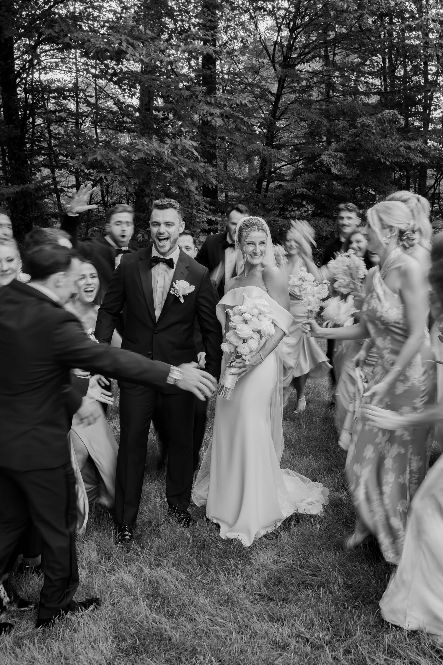 Wedding party having fun and laughing together in a black and white outdoor photo sequence.