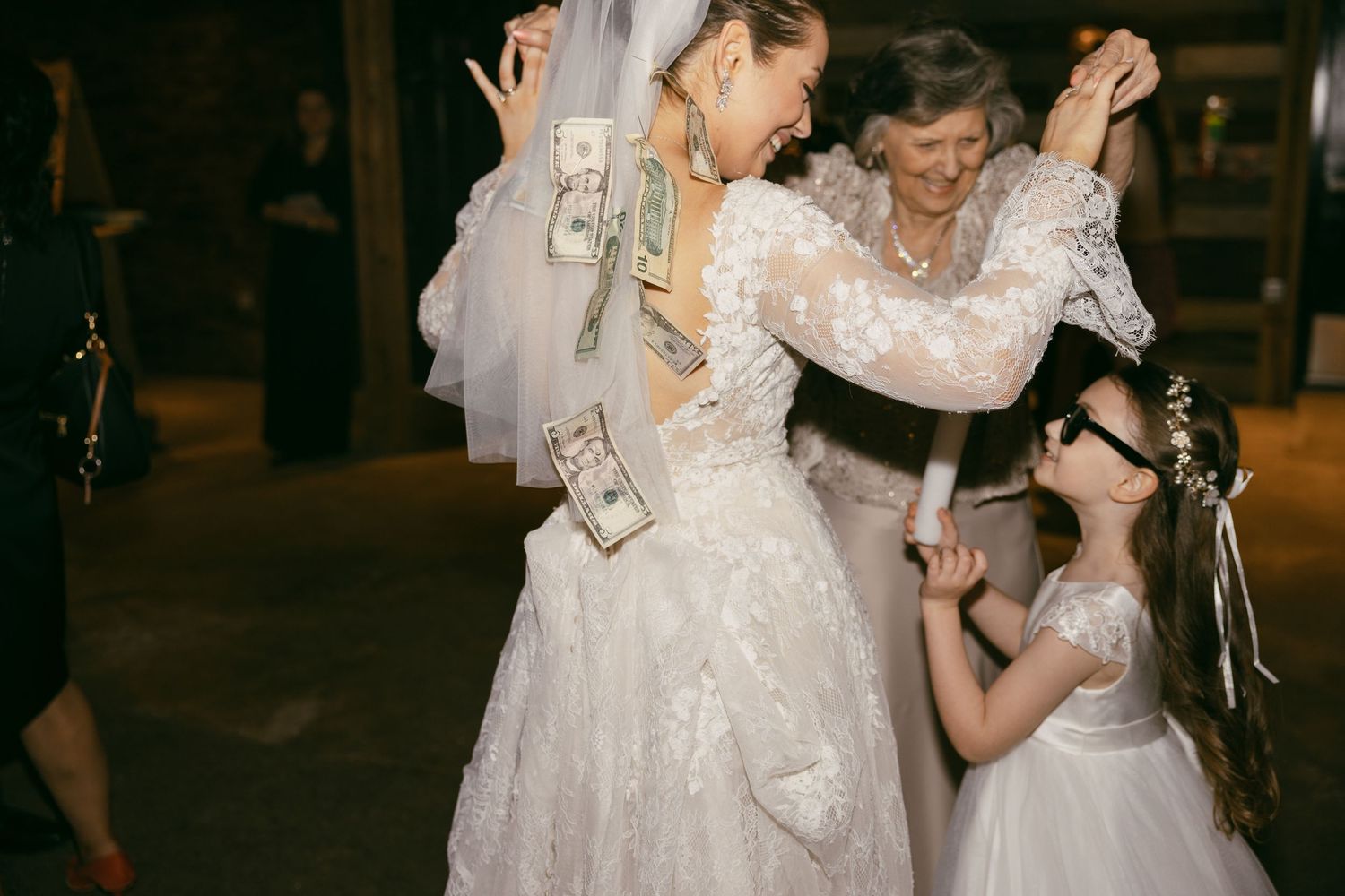 Wedding reception candid moment with guests dancing and celebrating.