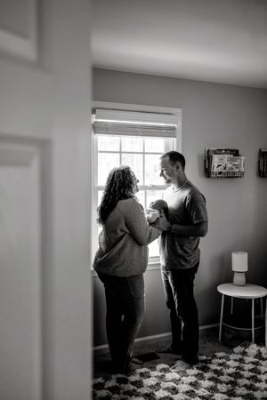 Black and white indoor newborn photography session showing intimate moments.