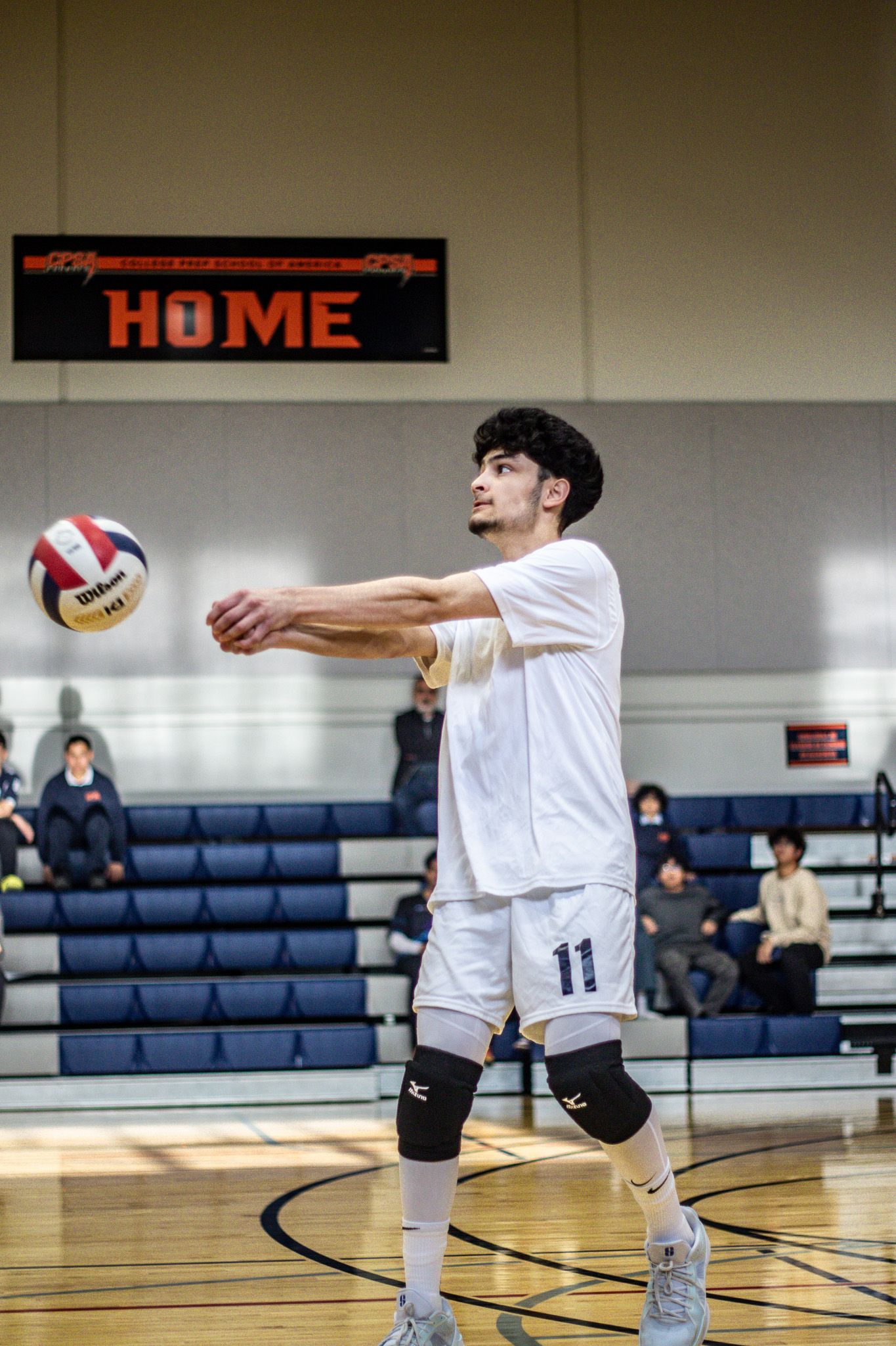 CPSA's #11 serving a volleyball.
