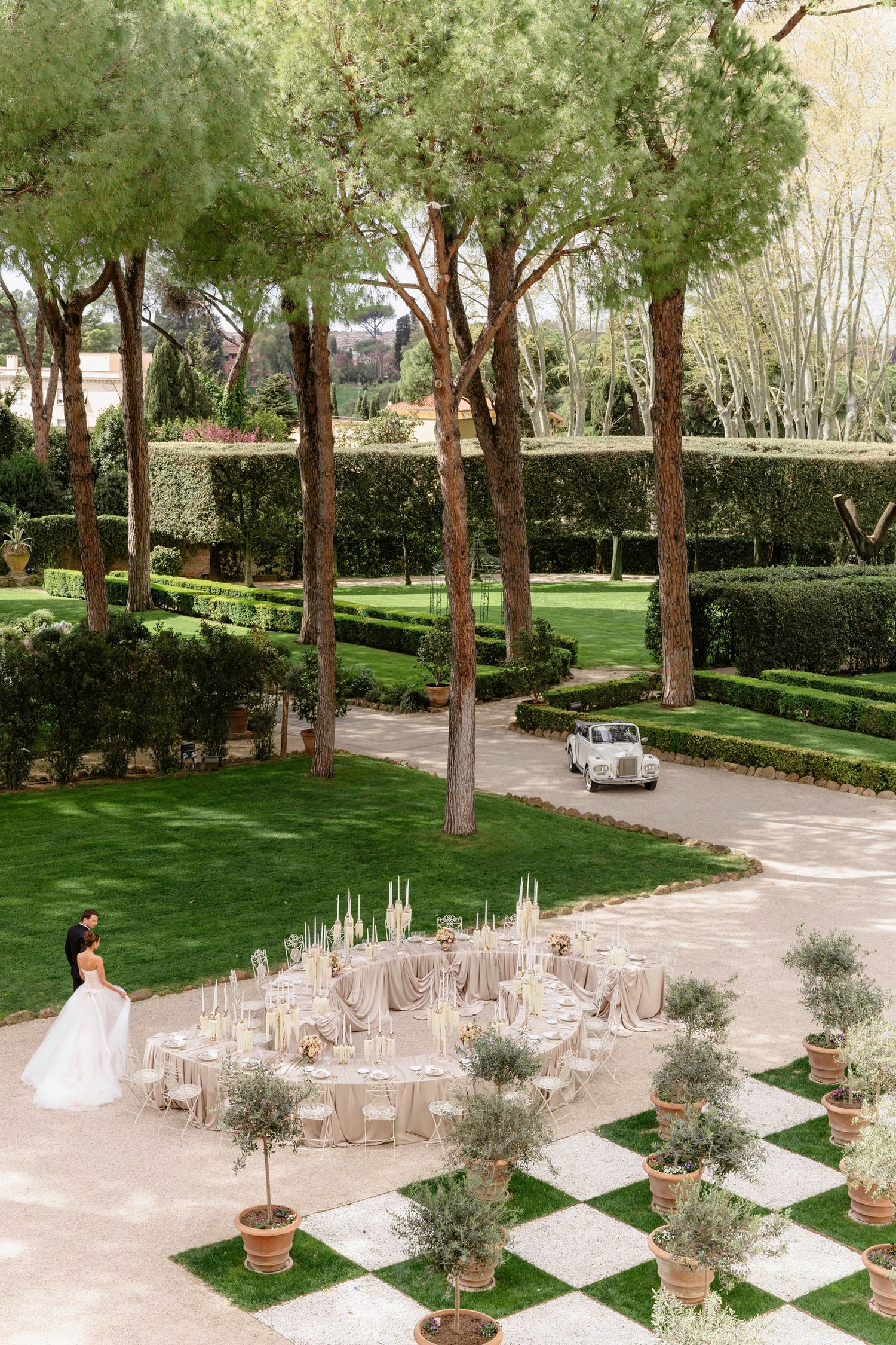 Romantic couple sitting in elegant archway entrance of classic building. Rome, Villa Aurelia