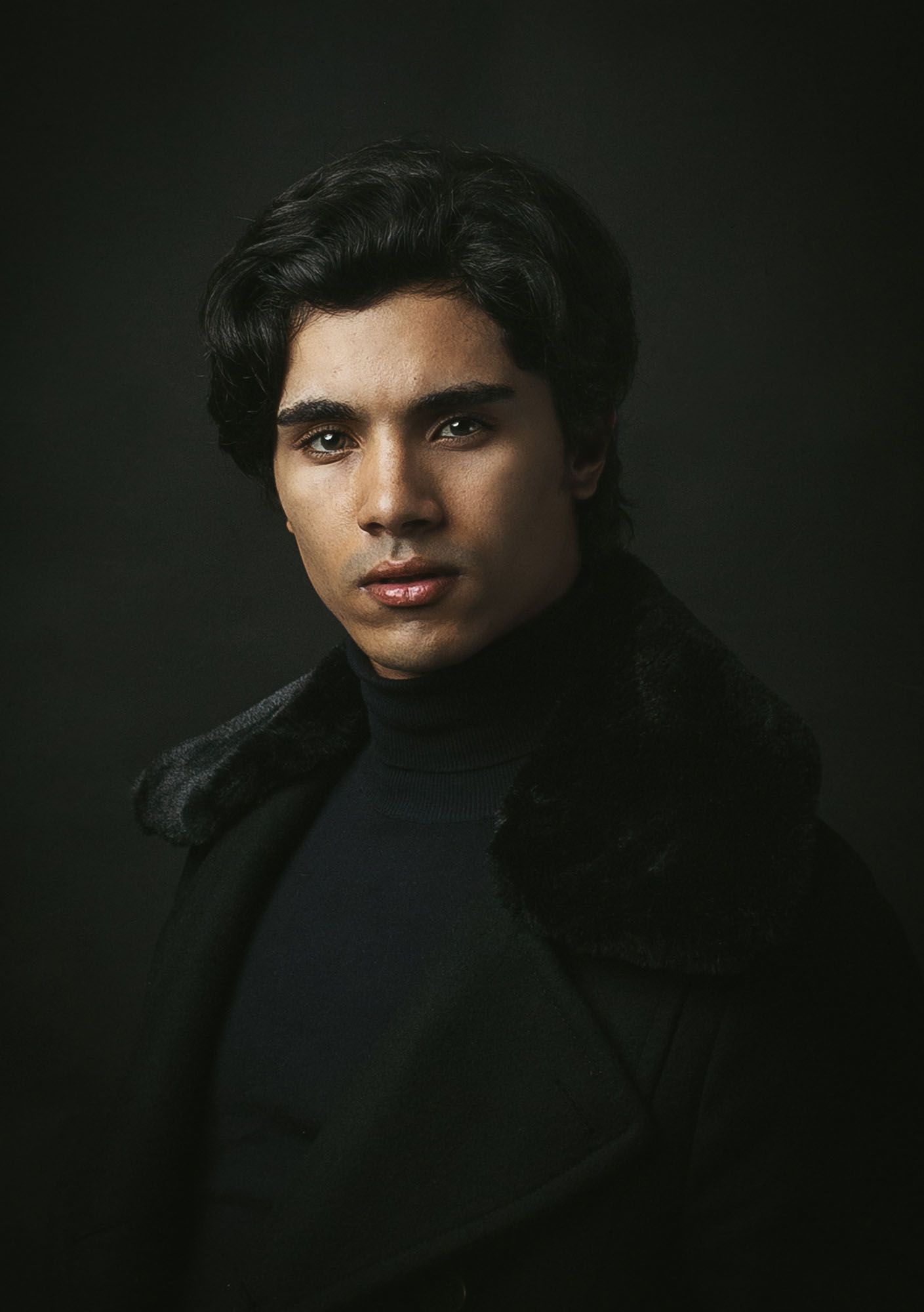 Portrait of a man in black outfit, Fashion Portrait Photography session. Studio dramatic photography