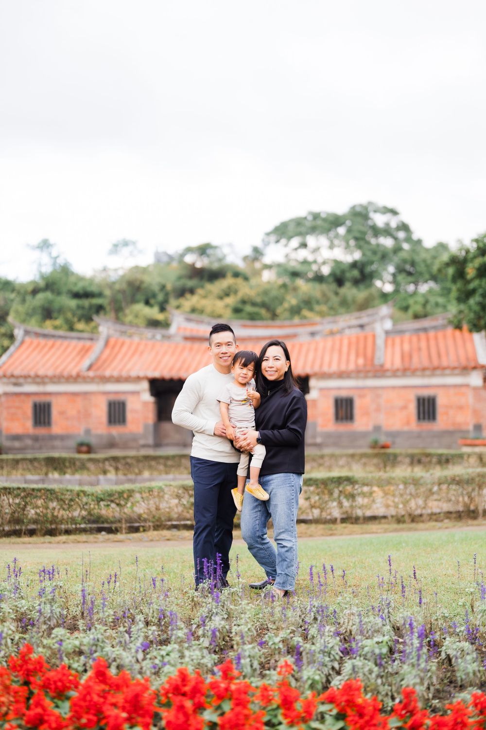 red flowers and a family at Lin An Tai Historical House and Museum