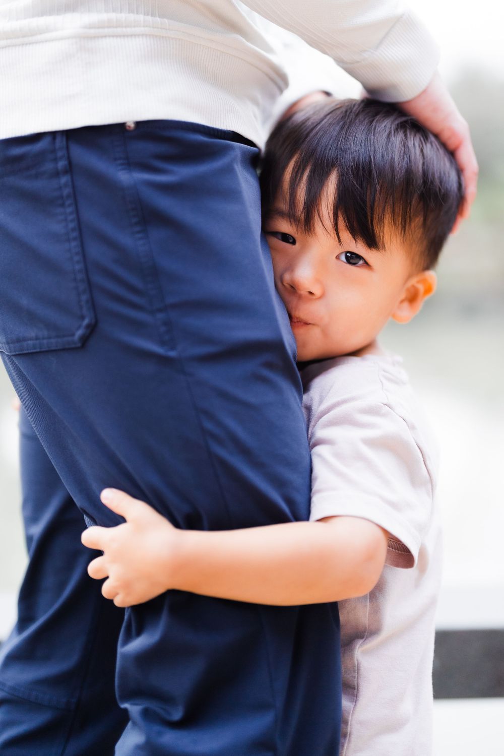 a kid holding onto dad's leg at Lin An Tai Historical House and Museum