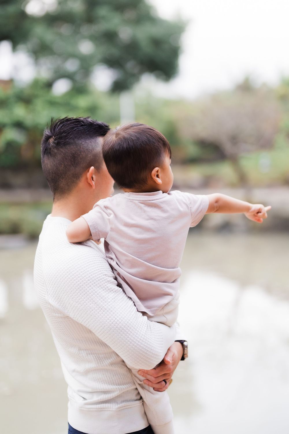son pointing out to the lake with dad at Lin An Tai Historical House and Museum