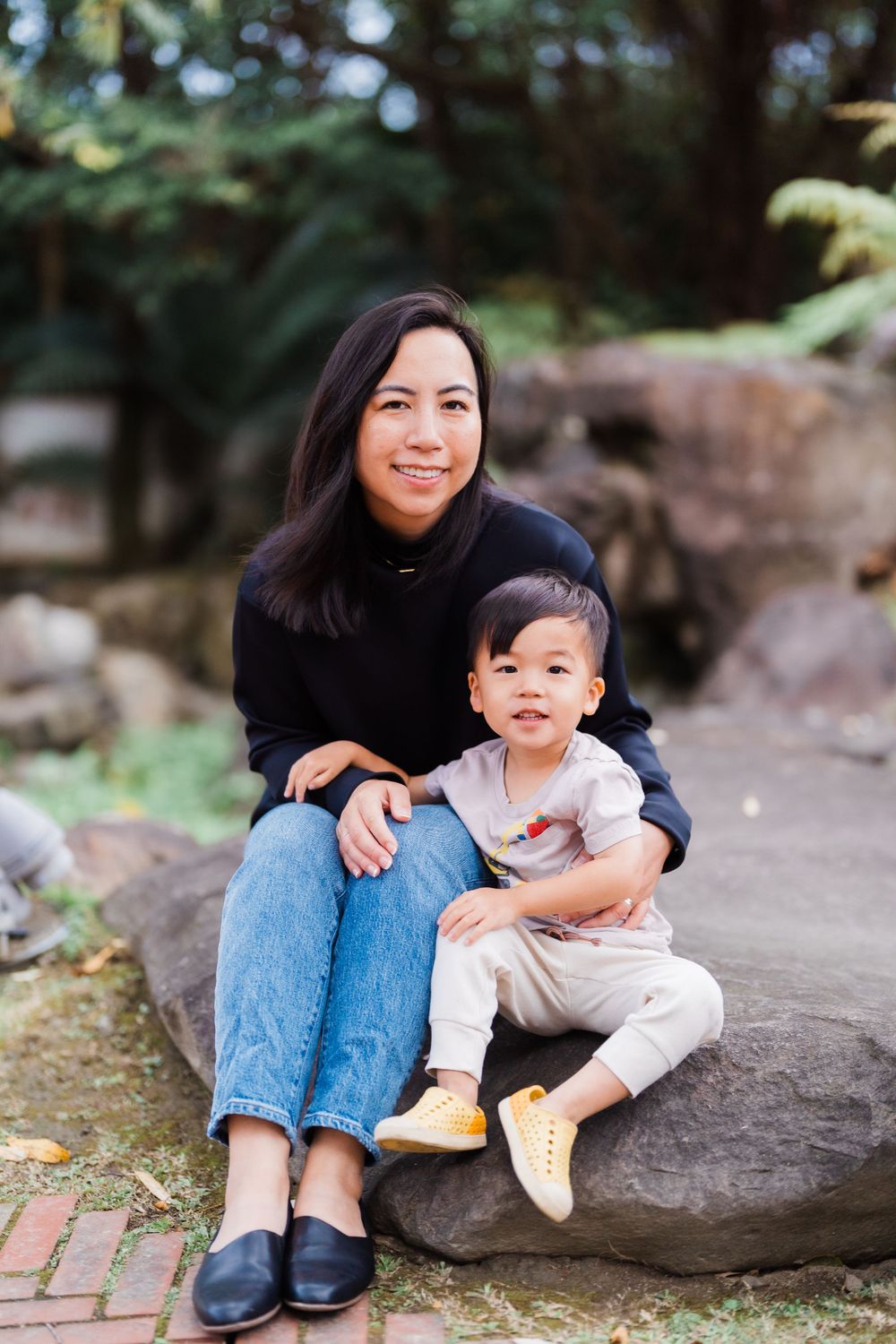 mom and son sitting on a rock at Lin An Tai Historical House and Museum