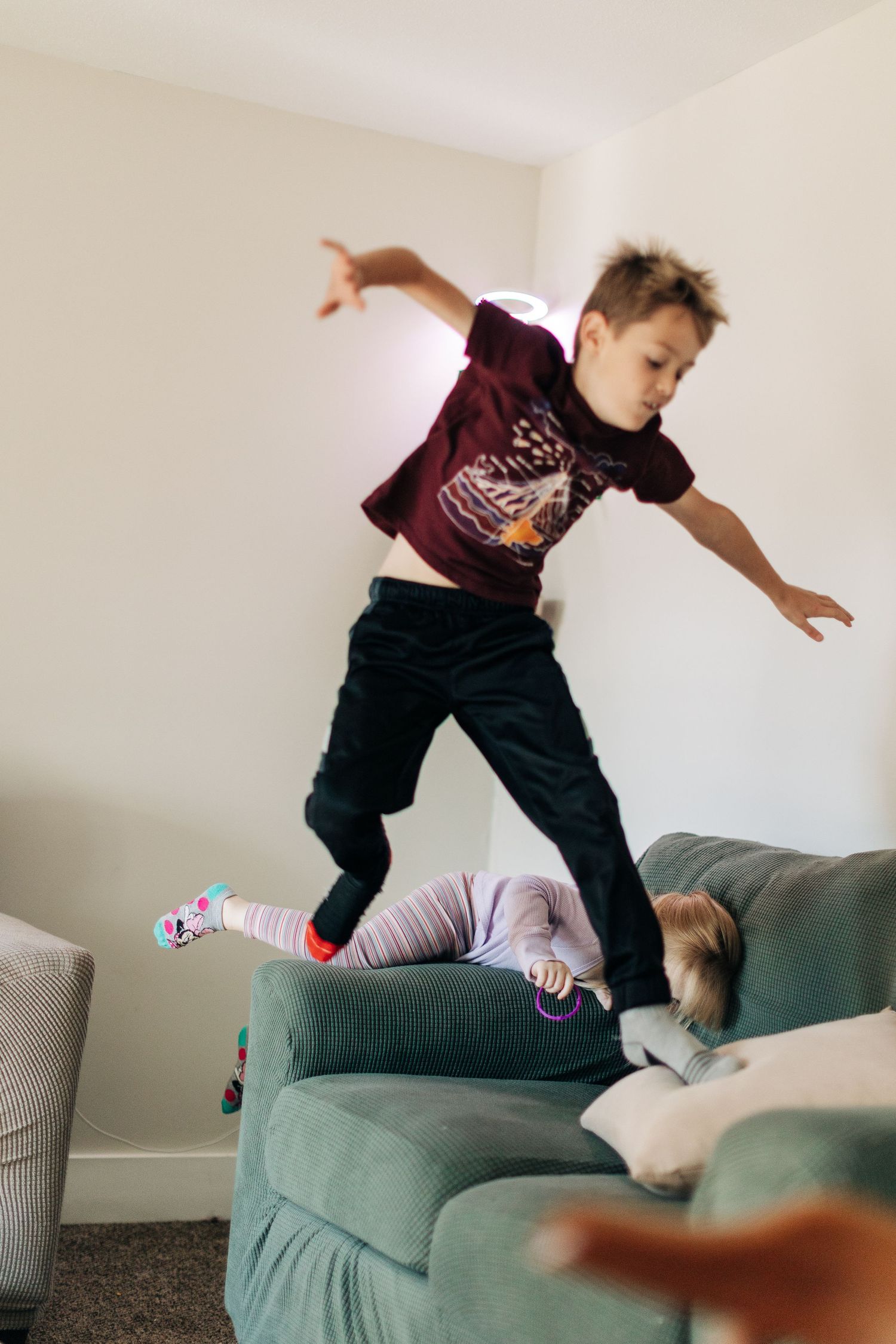 A child mid-jump on a couch showing playful energy and movement.