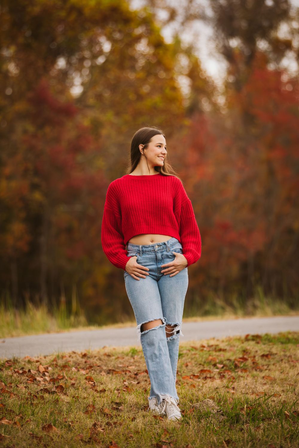 Senior session of girl in red sweater and jeans in fall season