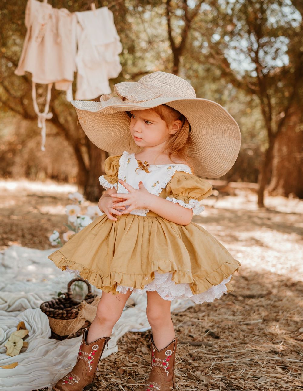 A collection of vintage-inspired photos featuring cowboy boots, ruffled dress, and straw hat in a woodland setting.