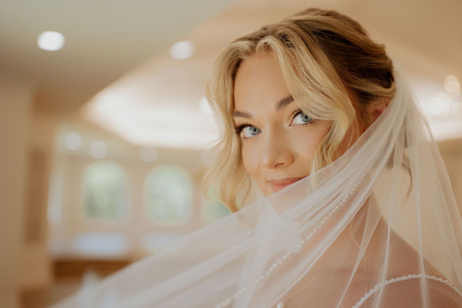 A portrait with white flowers and green leaves in soft natural light.