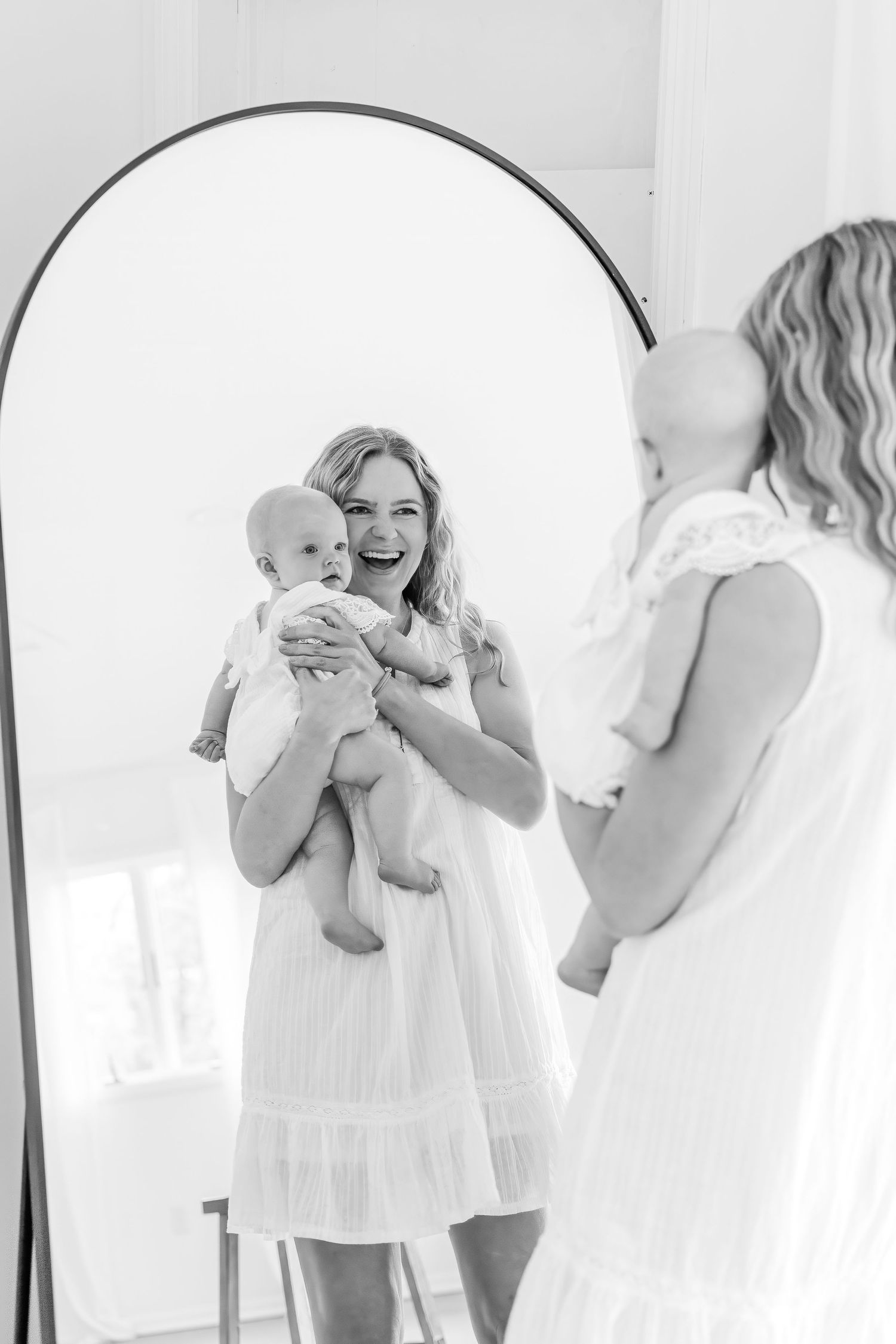 Series of joyful moments between mother and baby in white dresses.