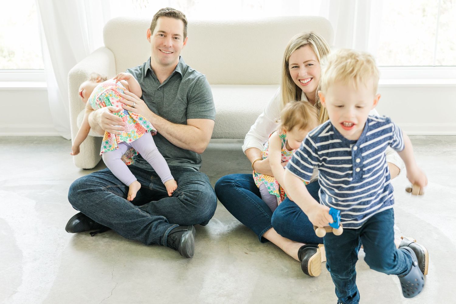 Parent and child sharing playful interactions during casual indoor photoshoot.