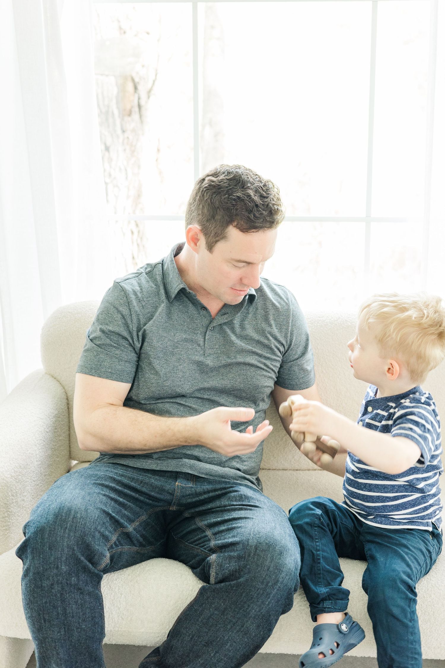 Parent and toddler sharing authentic moments during lifestyle photo session.