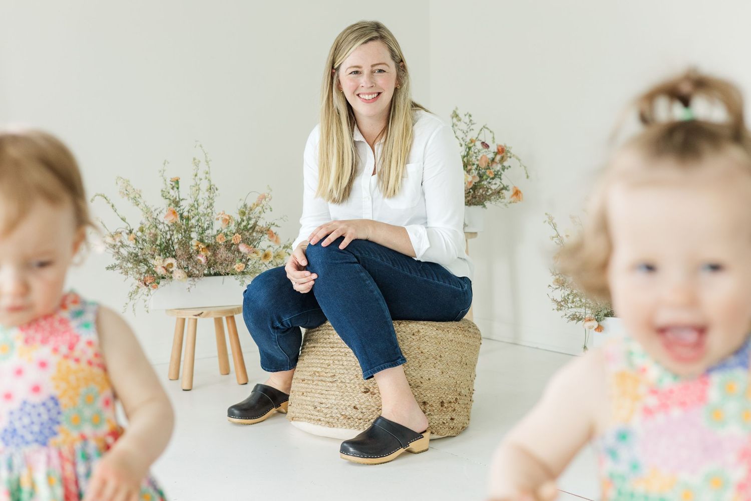 Joyful family photo session featuring natural interactions in light-filled studio.