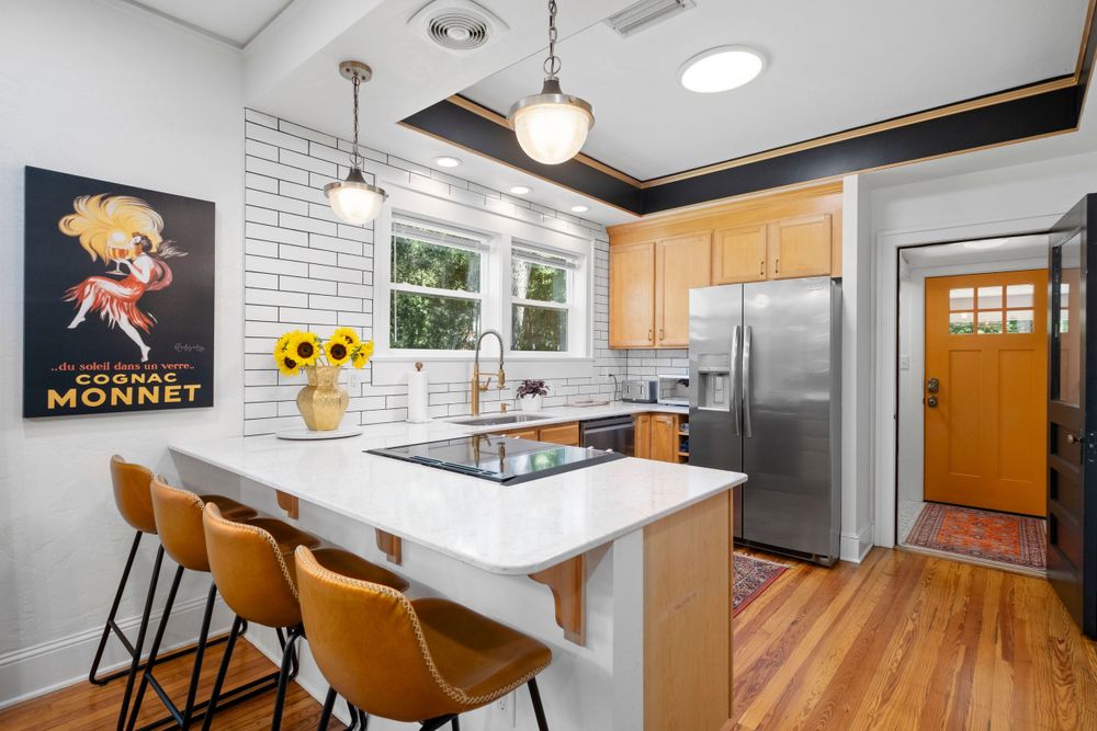 Architectural photograph of a kitchen with four stools sit at a counter at an AirBnb in Gainesville Fl.