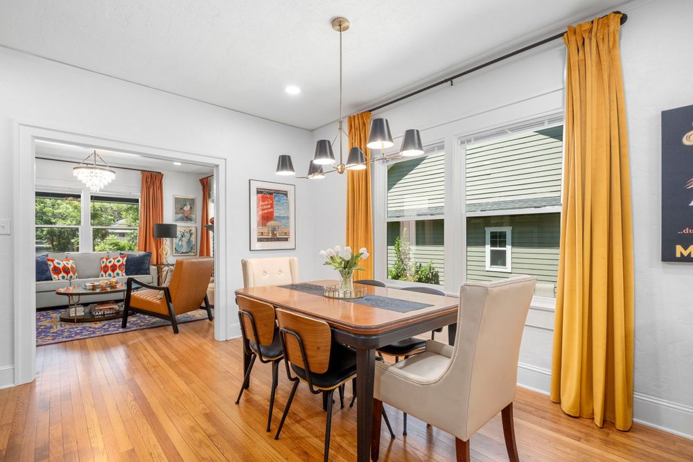 Gainesville real estate photograph of a dinging room leading into a living room at an Air Bnb.