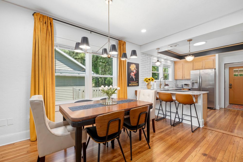 Real estate photograph of mid century furniture adorning an updated dining room in Gaiensville, Fl.