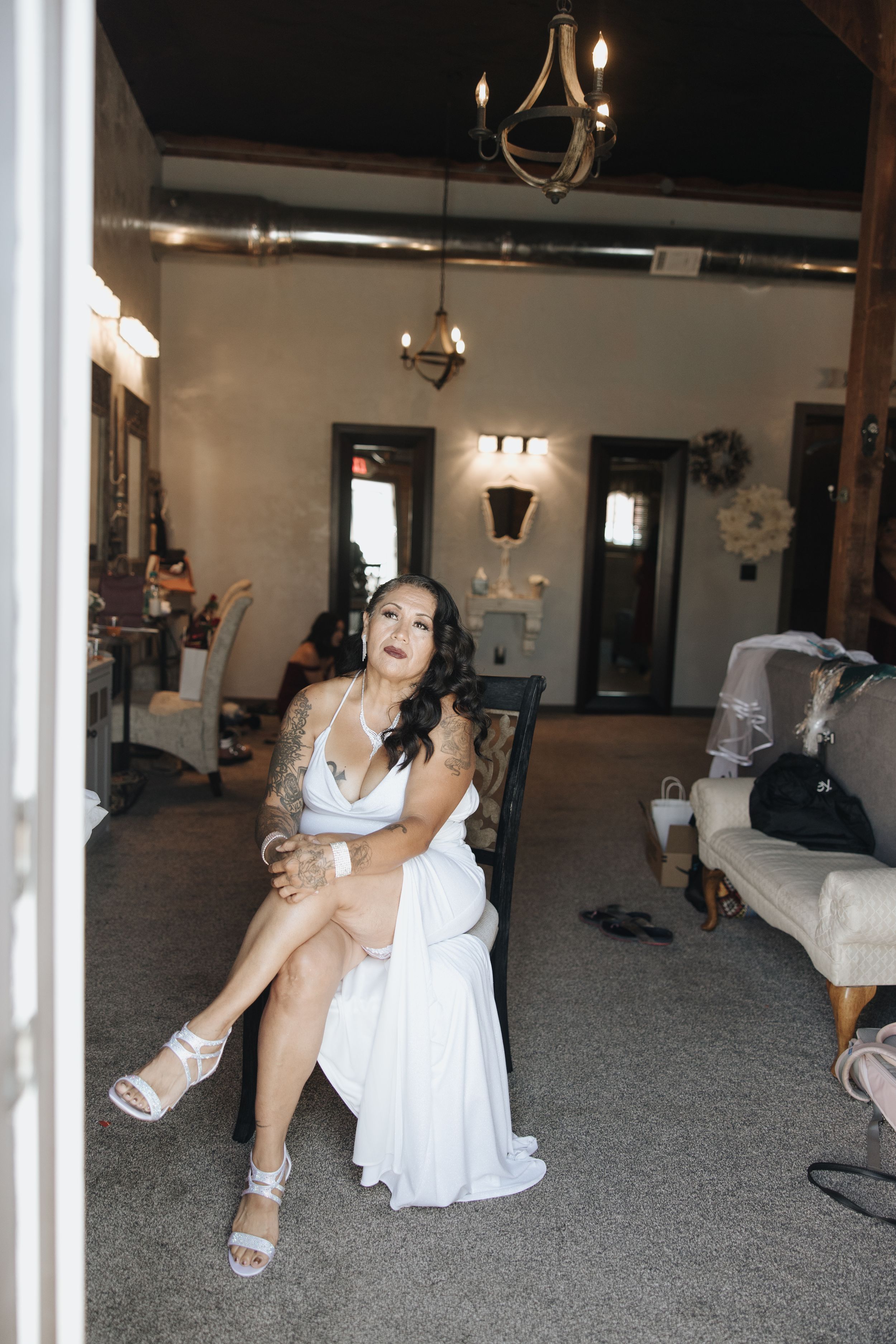 A glamorous bridal portrait in an elegant indoor setting with vintage lighting.