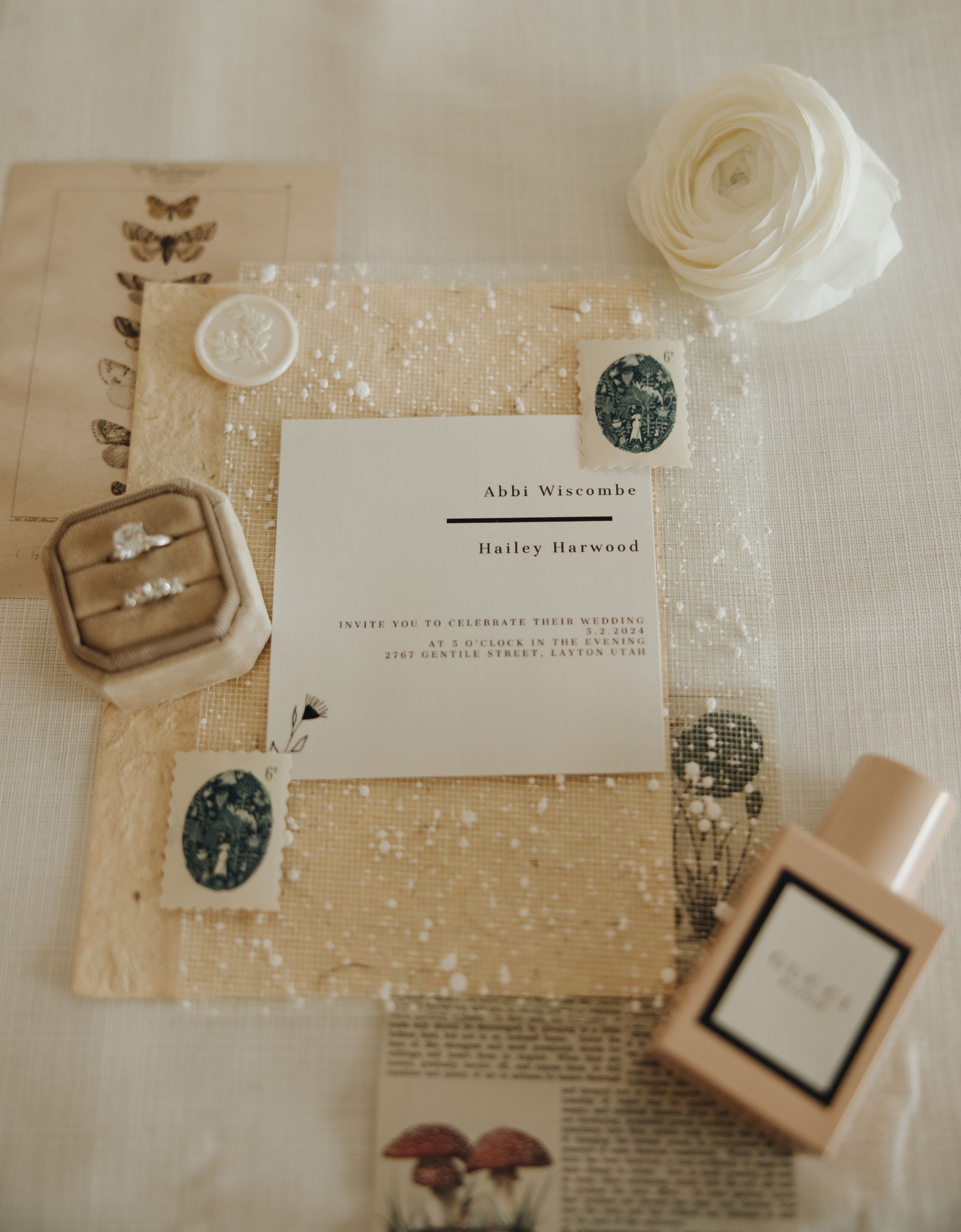 Wedding invitation flat lay with Starbucks stickers, rose decoration, and vintage-style details.