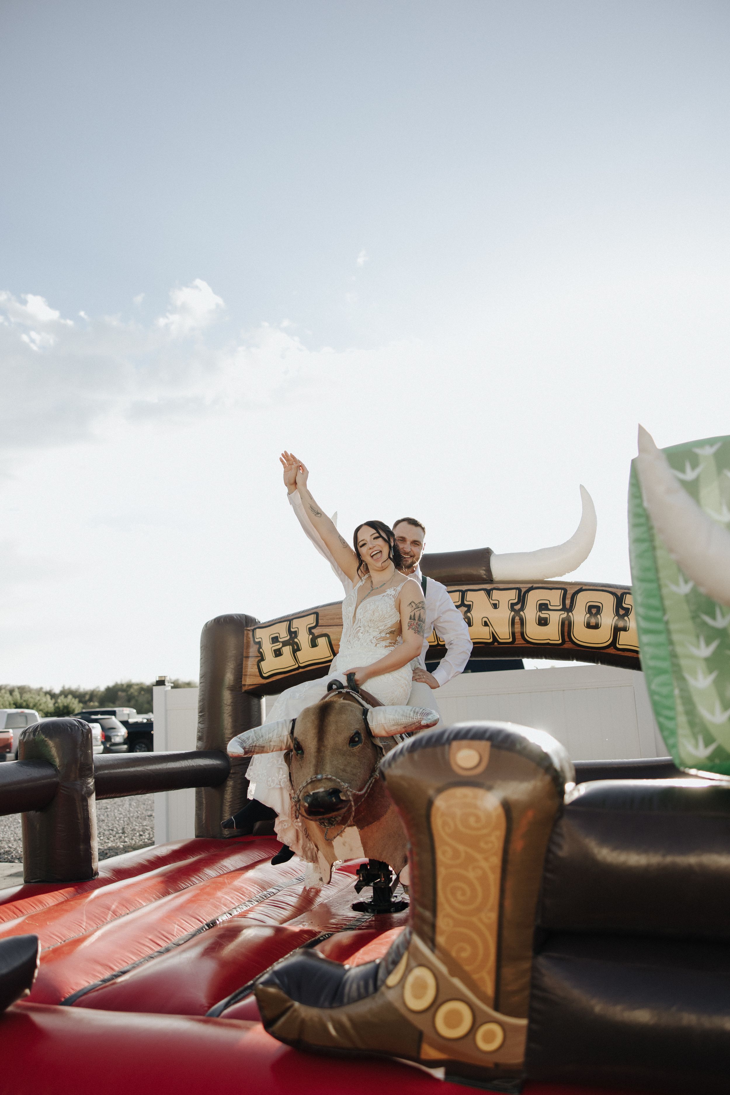A sequence of images showing a couple celebrating on a red car hood with a wooden sign.