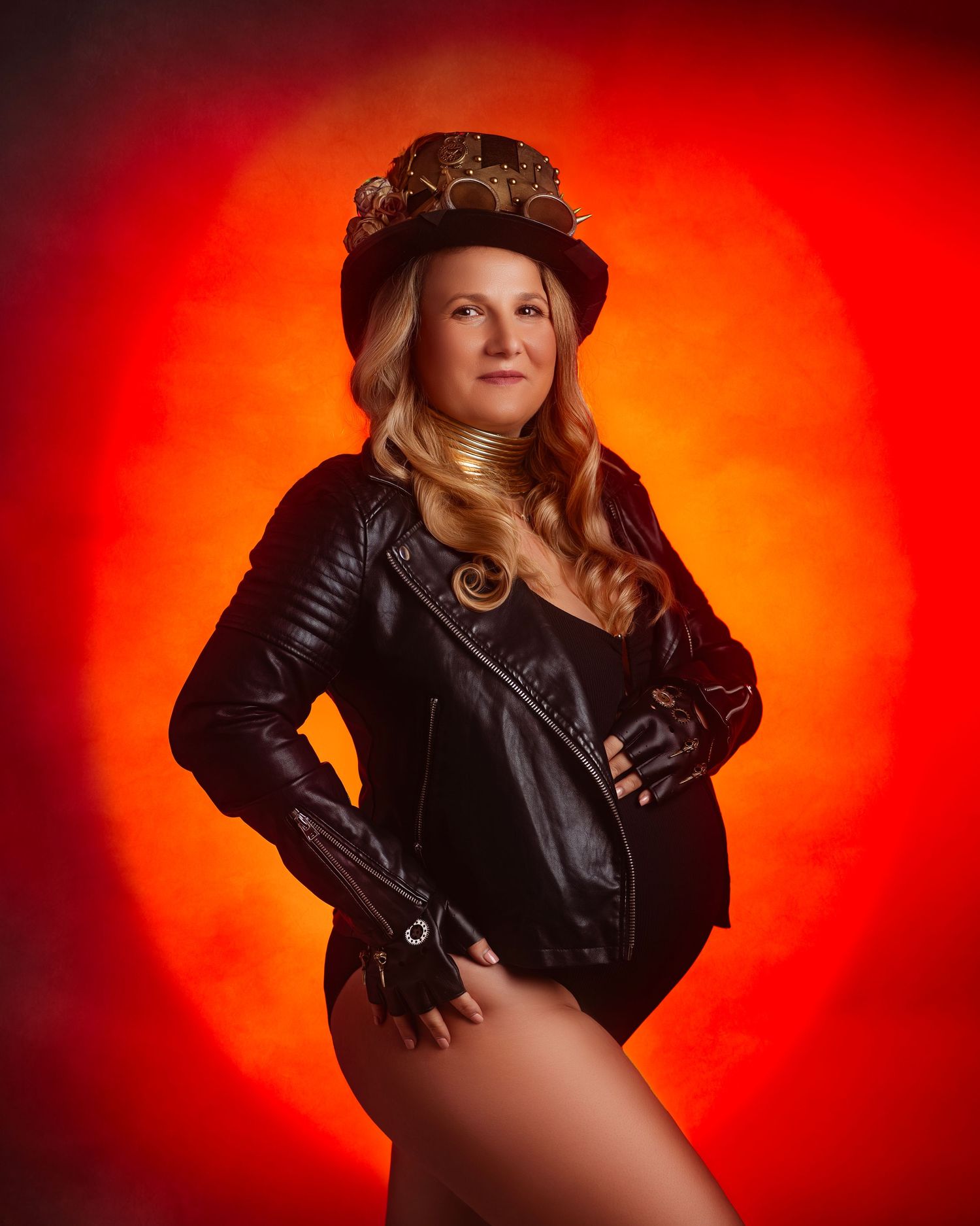 Dramatic portrait against vibrant red background featuring leather jacket and vintage hat with moody lighting effects.