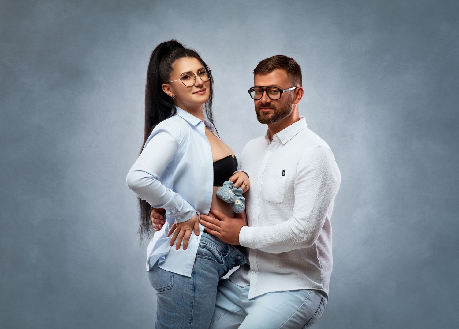 Several romantic candid photos show a couple wearing white shirts embracing and laughing together against a gray backdrop.