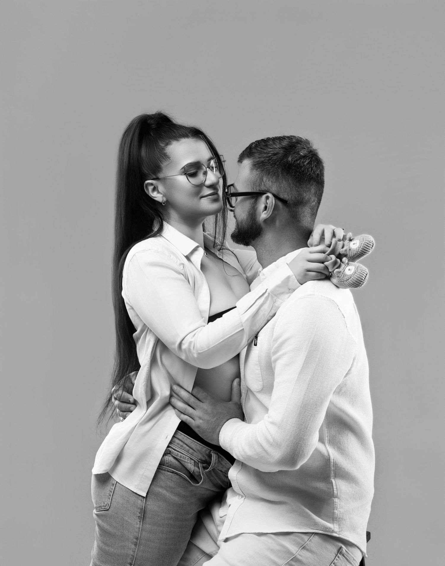A sequence of black and white photographs showing a couple dancing, with the background in shadow.