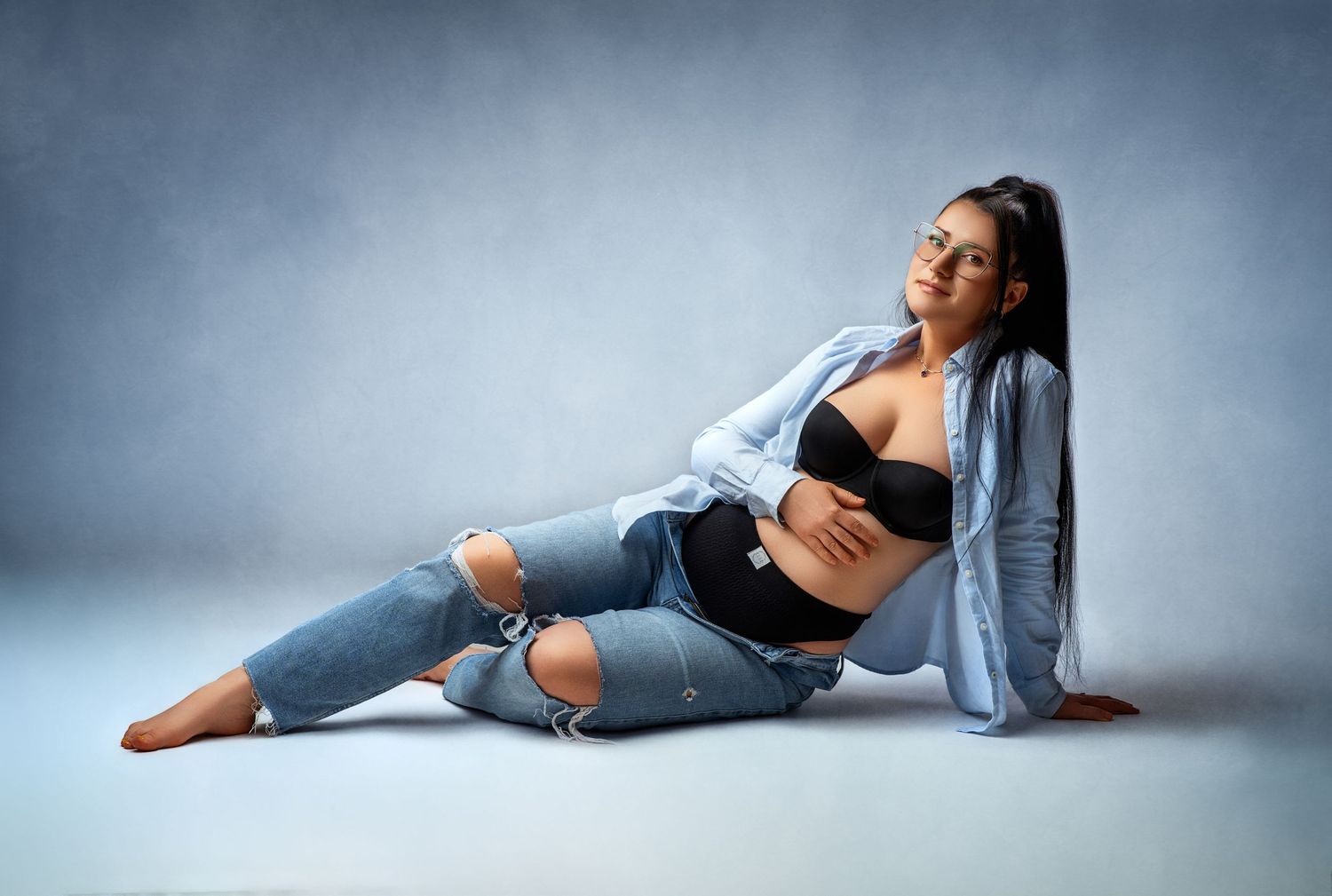 A series of artistic dance poses performed in blue denim jeans against a minimalist gray studio backdrop.