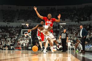 College basketball players compete in a fast-paced game with Ole Miss players defending against opponents.