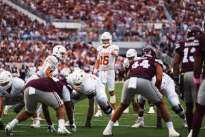 Football teams face off at the line of scrimmage during an intense game.