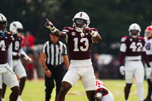Football players in action on the field during an intense play.