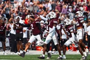 Football players lined up at the line of scrimmage before the snap.