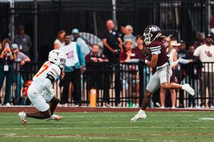 Wide angle view of a football field during a game with players lined up for a play.