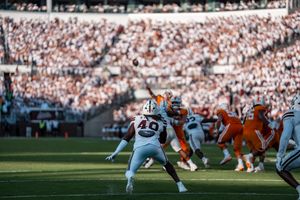 Football players line up at the line of scrimmage with Tennessee in orange jerseys facing their opponents.