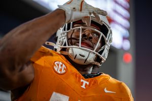 Close-up view of orange Tennessee football uniforms and helmets during game action.