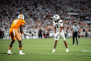 Football players position themselves at the line of scrimmage during a tense moment.