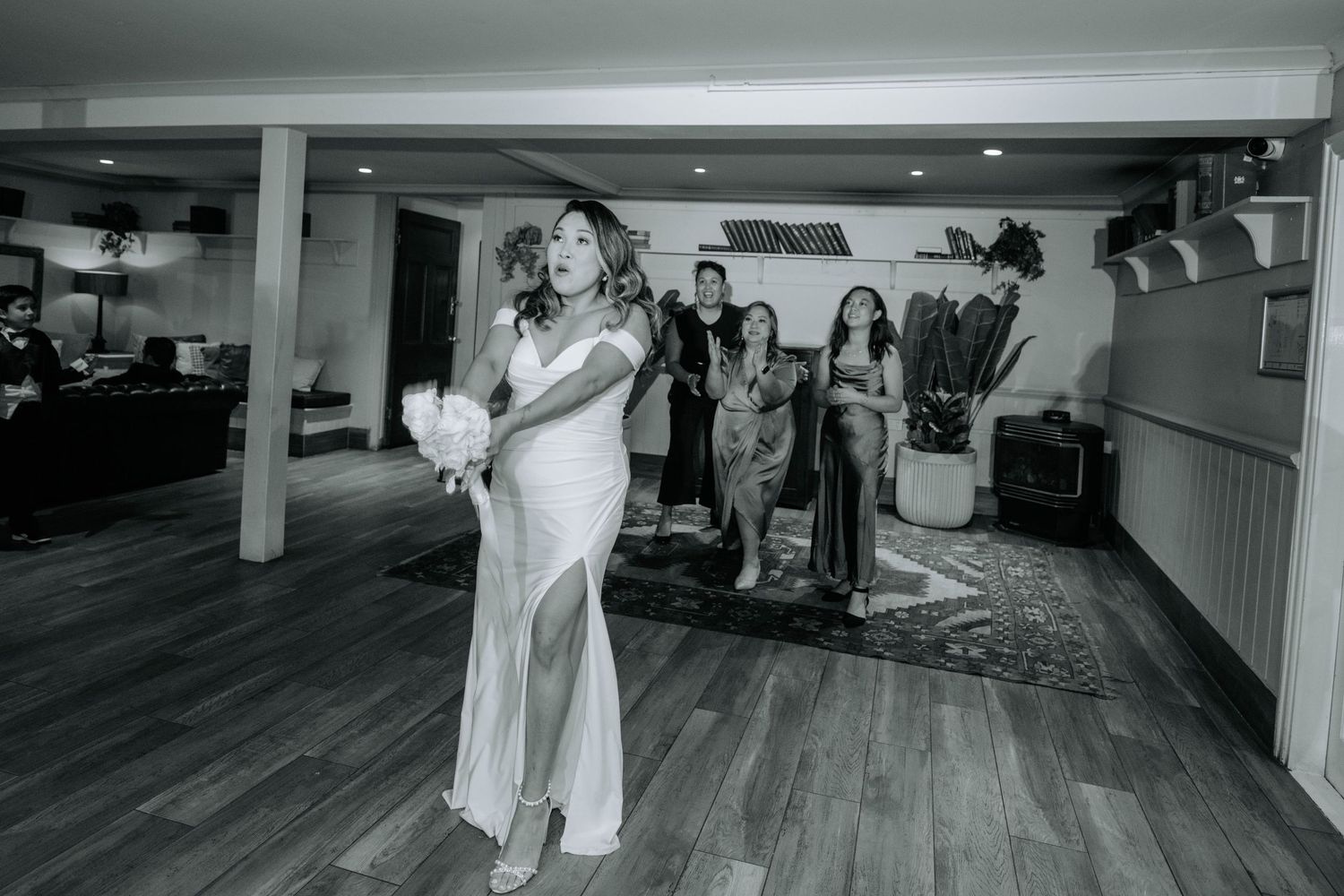Black and white image of a dance performance in an indoor venue.