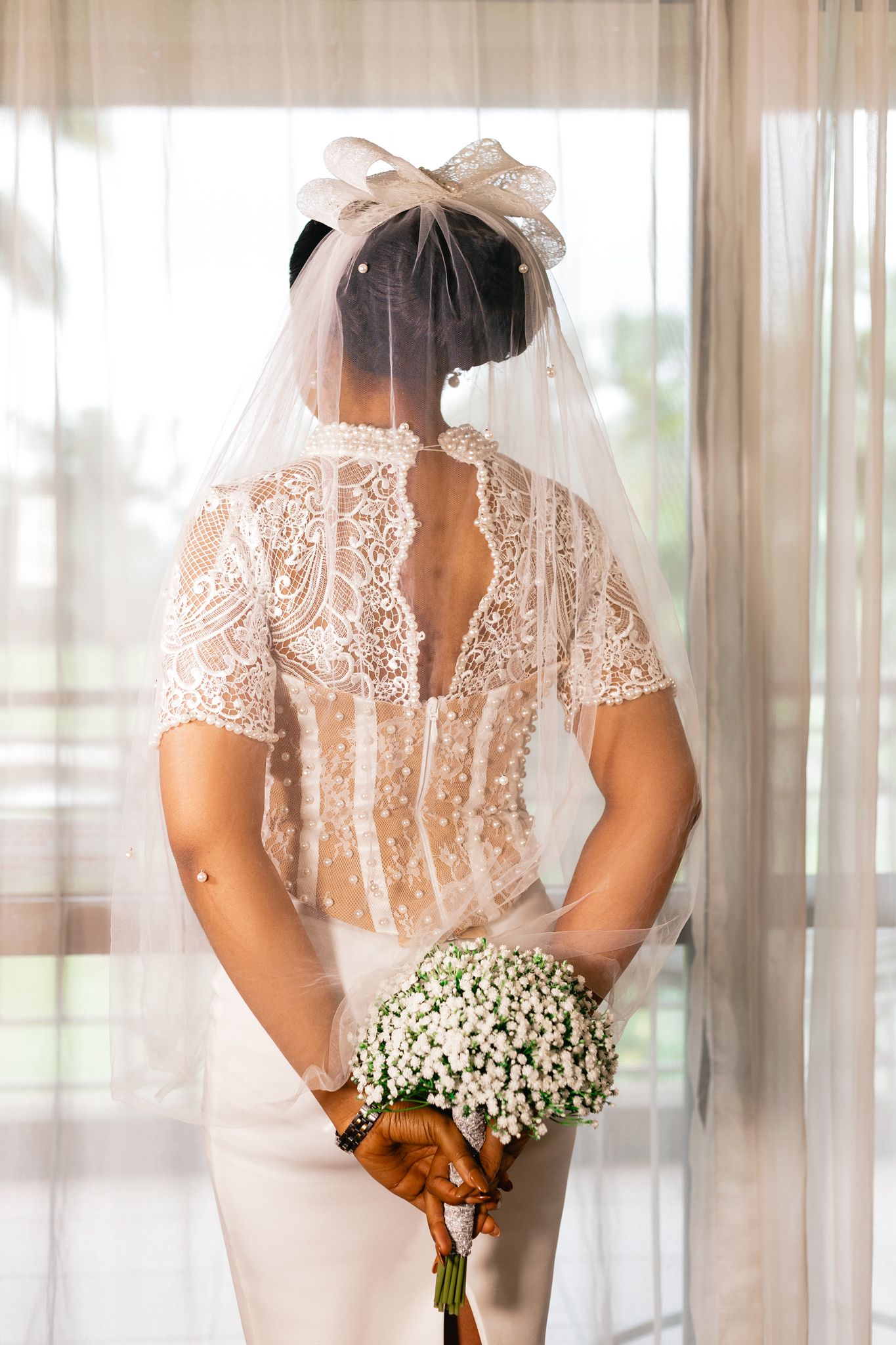 An editorial wedding image of a bride holding a bouquet captured by Monami Photography