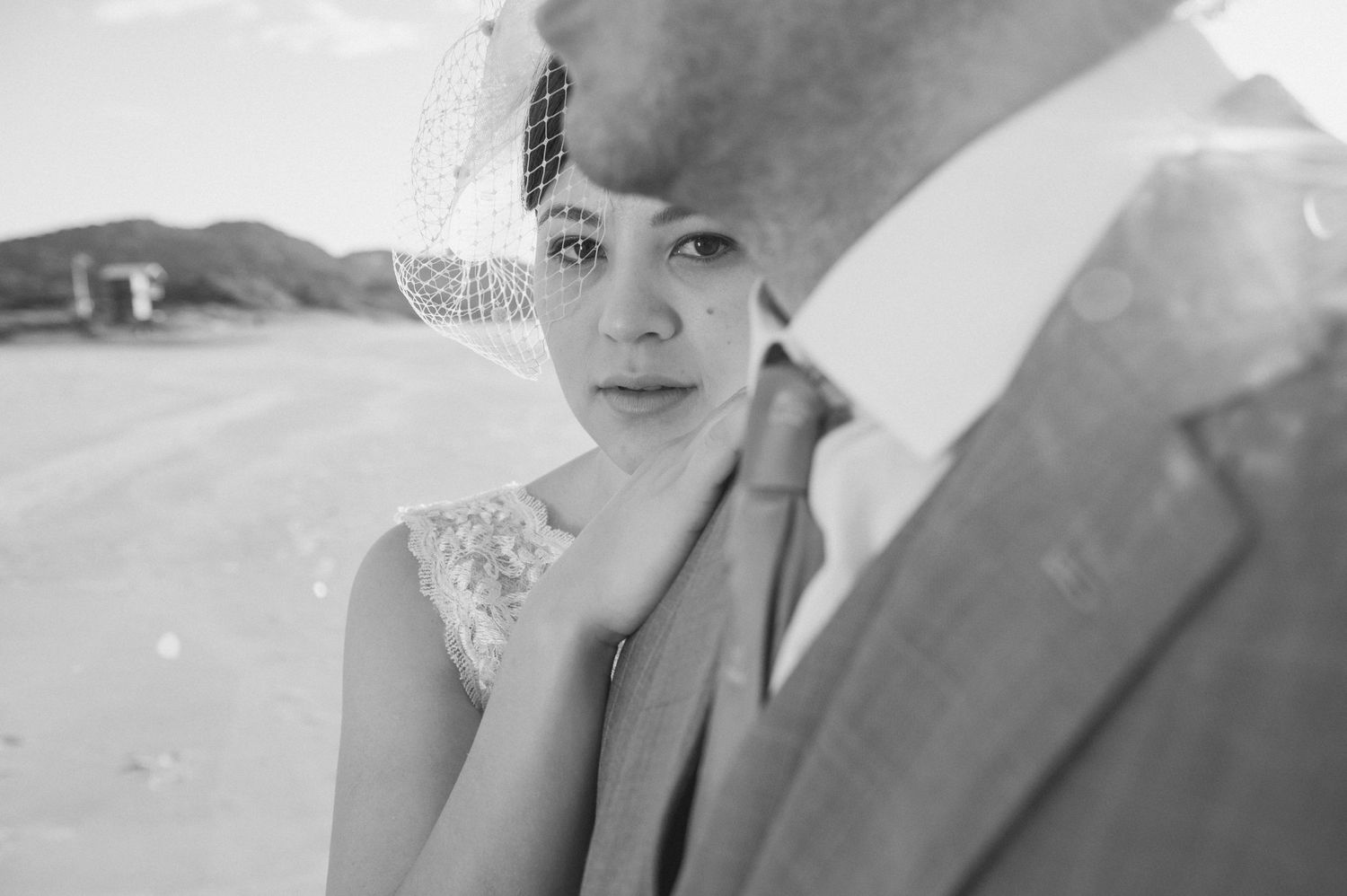 Vintage-style black and white wedding portrait with classic veil and lace details.