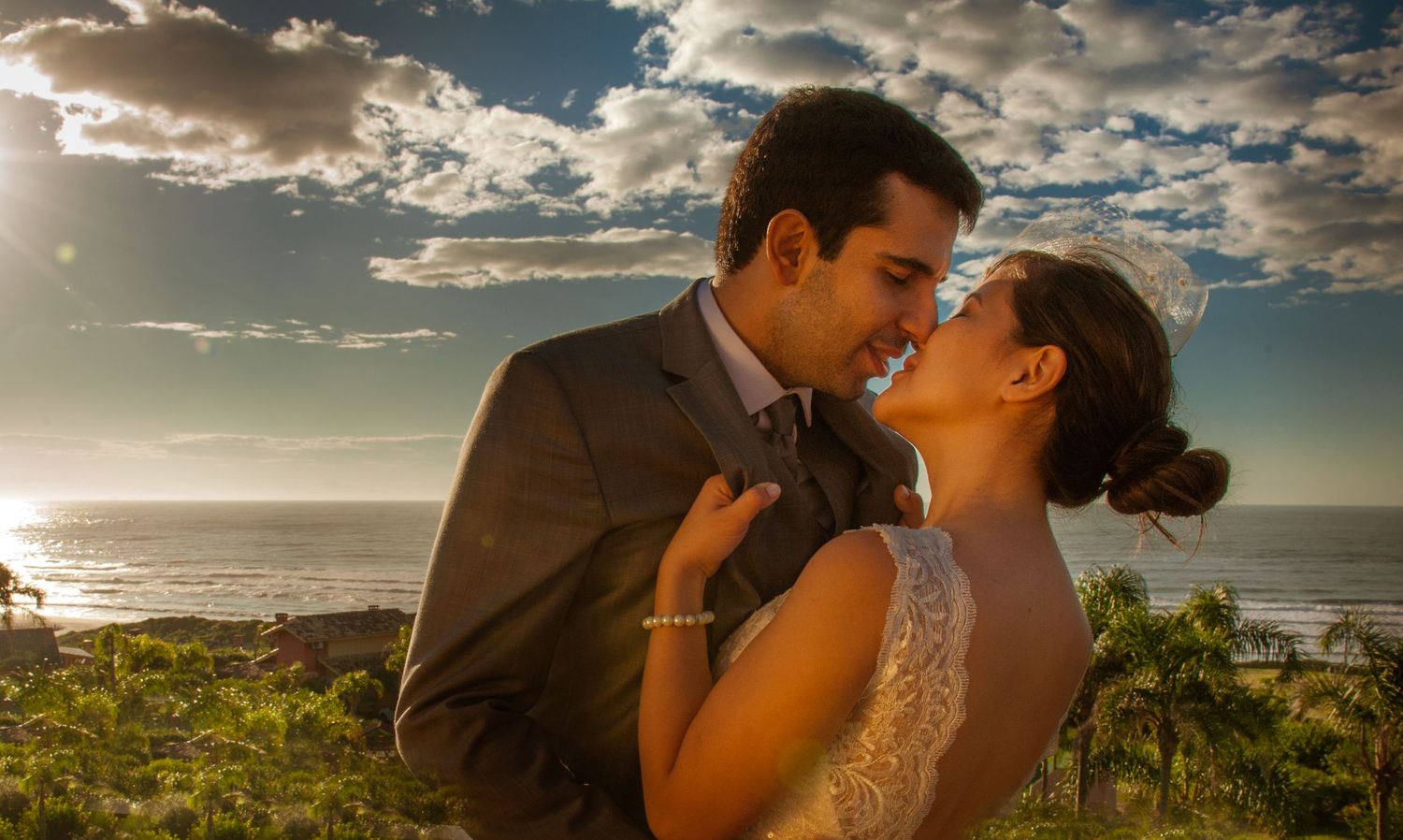 Romantic sunset moment overlooking the ocean with dramatic cloudy sky.