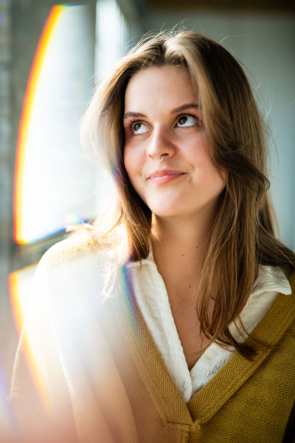 Beautiful portrait in soft natural lighting with a sunlit glow and dreamy lens flare effect.